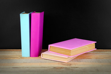 Books on a table on blackboard background