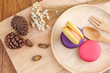 Tasty Sweet Macaroons on wooden background.