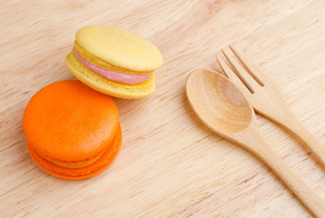 Tasty Sweet Macaroons on wooden background.