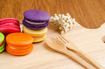 Tasty Sweet Macaroons on wooden background.