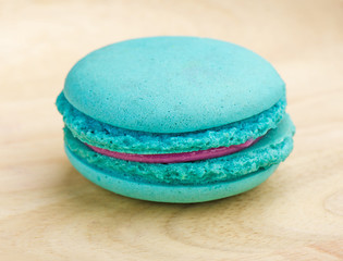 Tasty Sweet Macaroons on wooden background.