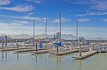 Fototapeta na wymiar Colorful Sailing Boats at Fishermans Wharf of San-Francisco Bay