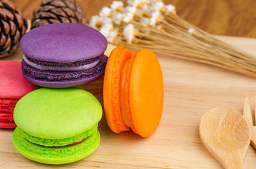 Tasty Sweet Macaroons on wooden background.
