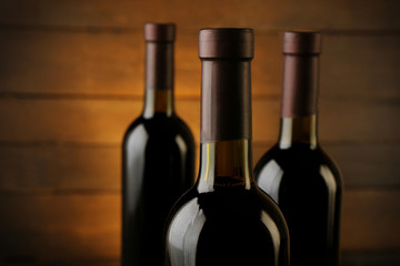 Wine bottles on wooden background, close up