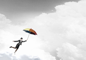 Woman flying on umbrella