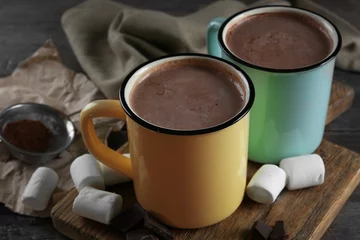 Fotobehang Tasty cocoa in metal old-fashioned mugs and marshmallow on the table © Africa Studio