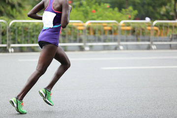 Marathon runner running on city road