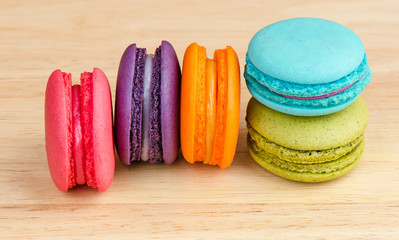 Tasty Sweet Macaroons on wooden background.