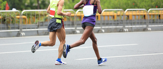 Fototapeta premium Marathon runners running on city road