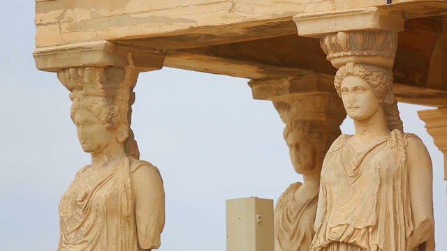 Huge marble female sculptures supporting entablature of ancient Greek palace