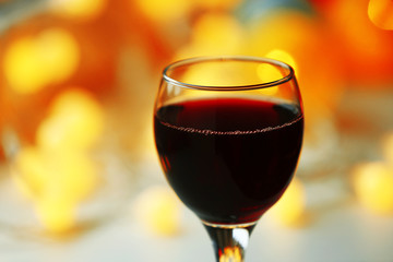 A glass of red wine on blurred background