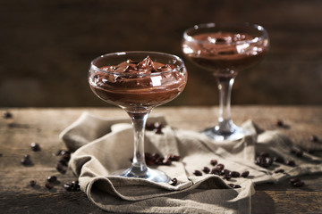 Chocolate dessert in glasses on wooden background