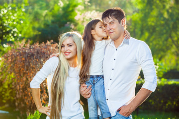 Happy family with child outdoors in jeans