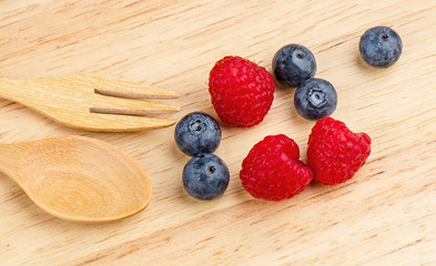 Raspberry and blueberry on wood background, Fresh fruit.