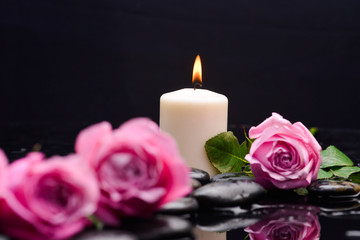 Still life with pink rose with candle and therapy stones 
