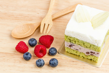 Green tea cake on wooden background, tasty cake.
