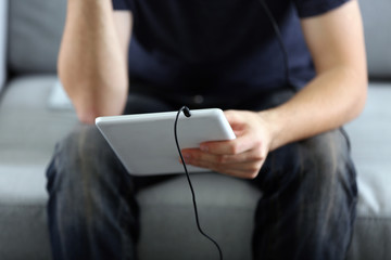 Man holds tablet in hands, close up