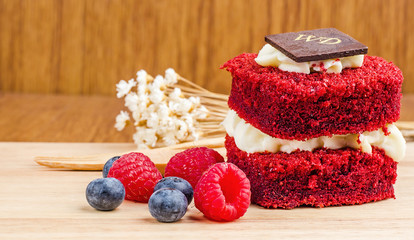 Red Velvet cake on wooden background, Shape of heart.