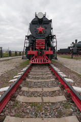 Old black steam locomotive on cloudy sky background. Nizhniy Novgorod, Russia. 
