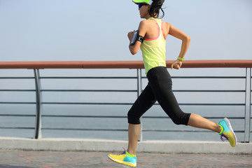 young fitness woman runner running at seaside