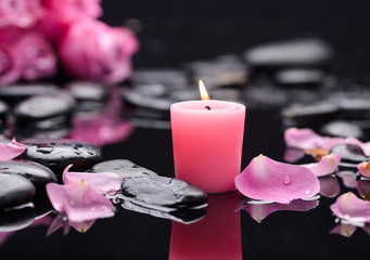 rose petals with candle and therapy stones 