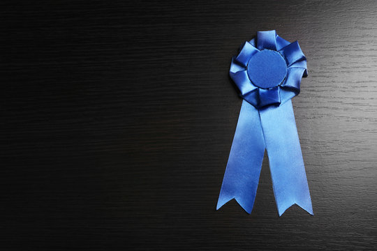 Award ribbons on dark wooden background