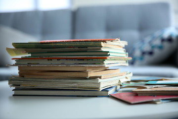 Pile of old books on white table in the room