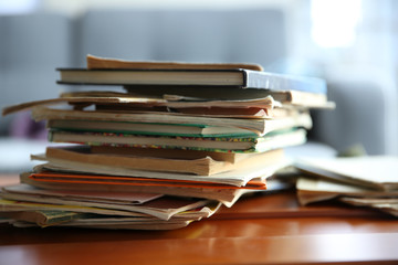 Pile of old books on brown table in the room