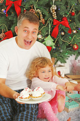 Father and daughter on Christmas interior background