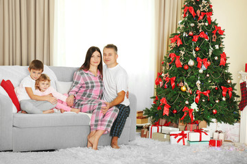 Christmas family portrait in home holiday living room, at christmas morning