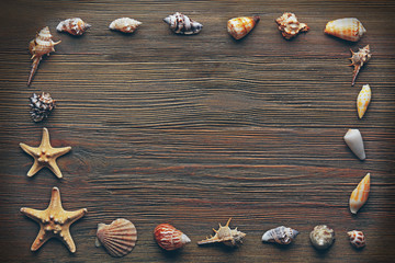 Seashell frame on wooden background