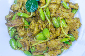fry pork with curry paste on wood table