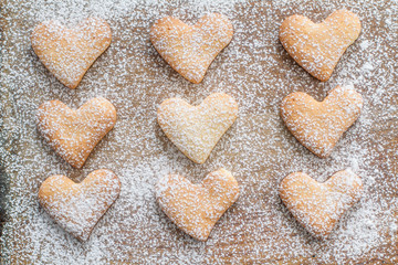 Heart shaped cookies on wood background