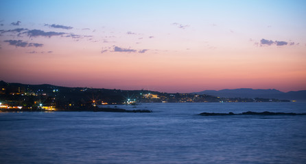 Night view of coastline with houses.