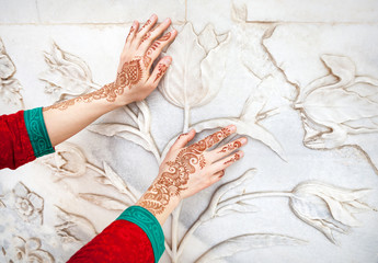 Woman hands in henna painting in India