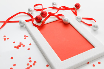 Greeting card template made of white frame and red card with red ribbon, silver and red balls and red confetti