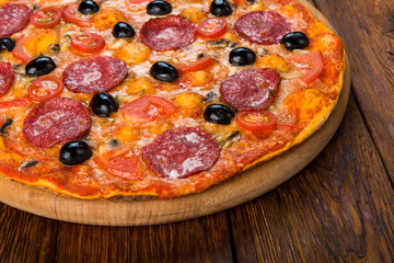Delicious pizza with salami, mushrooms and olives