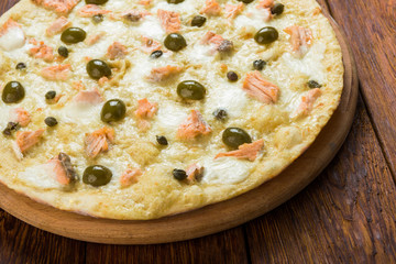 Delicious seafood pizza with olives
