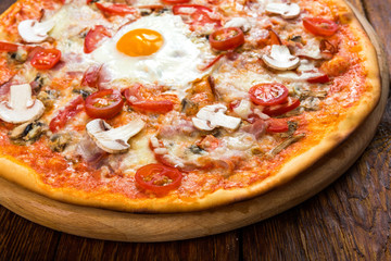 Delicious pizza with mushrooms, bacon and egg