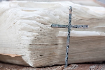 Silver christian cross on bible