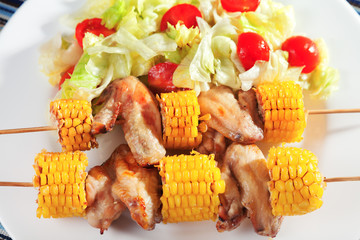Chicken wings with corn skewers