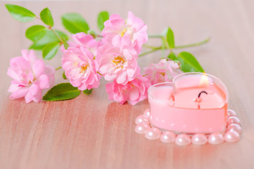 Obraz na płótnie Canvas Valentine card of pink heart shaped candle framed pearl beads an