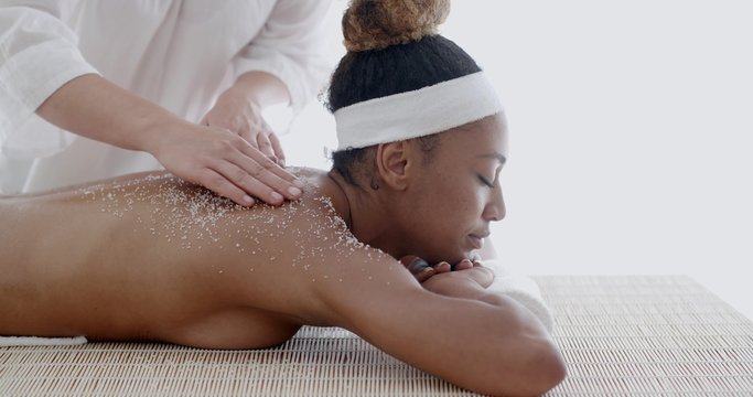 Female Getting A Salt Scrub Treatment