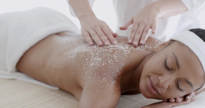 Female Getting A Salt Scrub Treatment