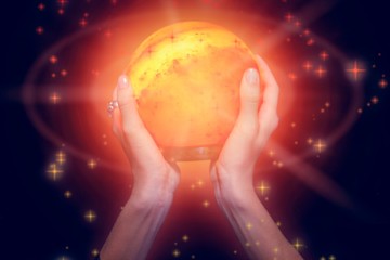 Composite image of fortune teller holding crystal ball