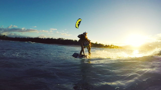 Extreme Kitesurfing at Sunset. Summer Ocean Sport in Slow Motion. Girl Kite Surfing in Bikini 