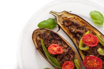 Eggplant with minced meat and vegetables on the white background top view
