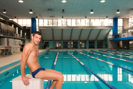 Portrait of professional man swimmer inside swimming pool.