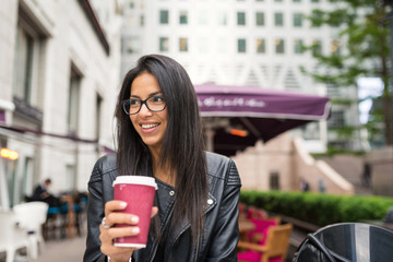 Smiling young mixed race businesswoman portrait outdoors in Canary Wharf in London.