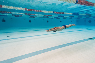 Professional man swimmer inside swimming pool.